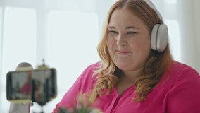 Closeup of cute overweight woman talking to subscribers, social media, blogger