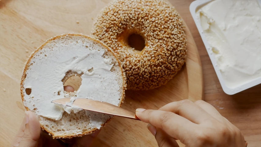 A bagel and cream cheese is a common food pairing in American cuisine, the cuisine of New York City, and American Jewish cuisine | Shutterstock HD Video #1097223129