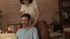 Happy senior man receiving a shoulder massage from his wife. - Powered by Shutterstock - Get 15% off with code: PIKWIZARD15