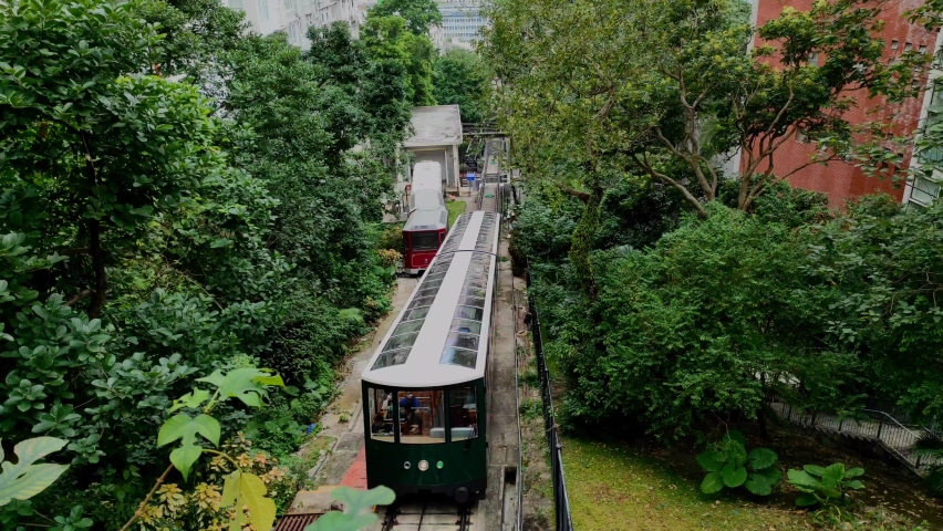 The sixth generation Peak Tram .The Peak Tram is a funicular railway in Hong Kong, which takes tourists and residents to the upper levels of Hong Kong Island. Royalty-Free Stock Footage #1097231141