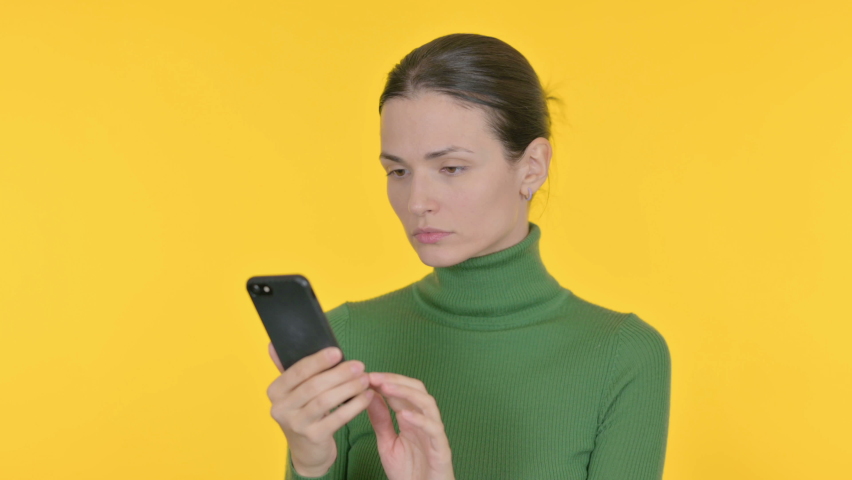 Beautiful Woman Loss on Smartphone on Yellow Background  | Shutterstock HD Video #1097231767