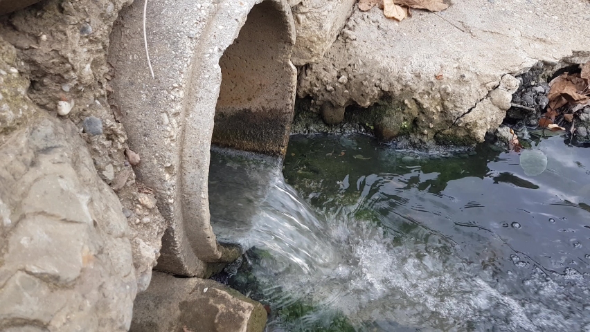 A concrete water pipe through which polluted water and fecal sewage flows | Shutterstock HD Video #1097235167