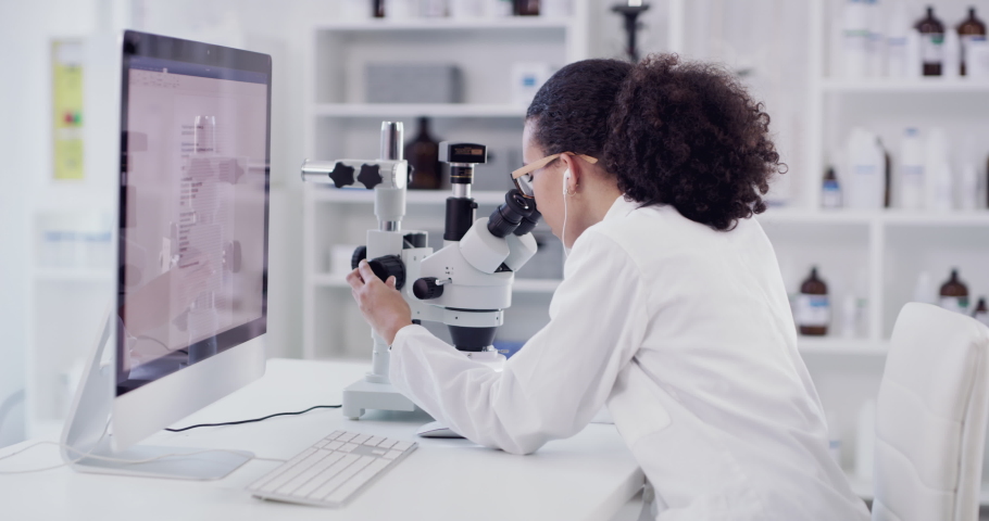 Research, science and music with black woman in laboratory with microscope and computer for medicine, vaccine and biotechnology. Analytics, innovation and idea with scientist listening to earphones | Shutterstock HD Video #1097235391