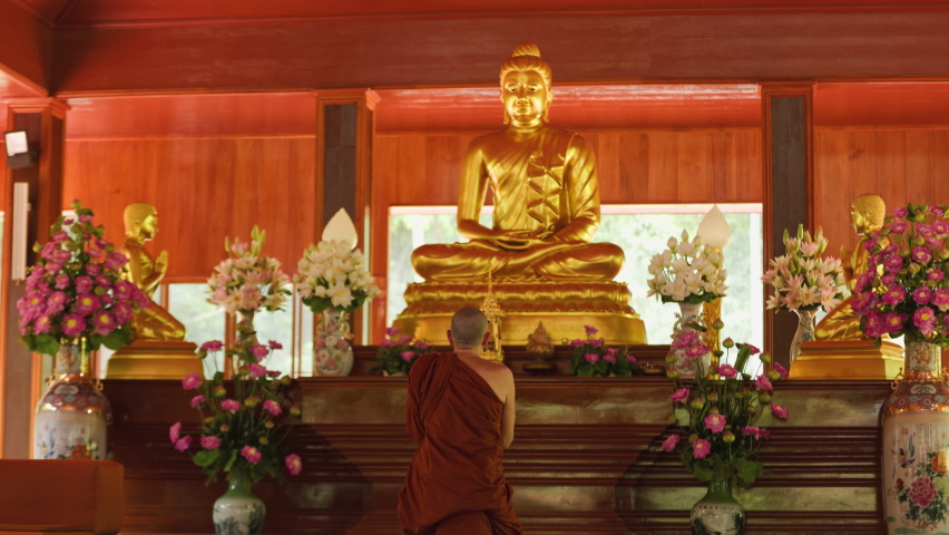 Buddhist monk bows in front of Buddha statue in temple Royalty-Free Stock Footage #1097237203