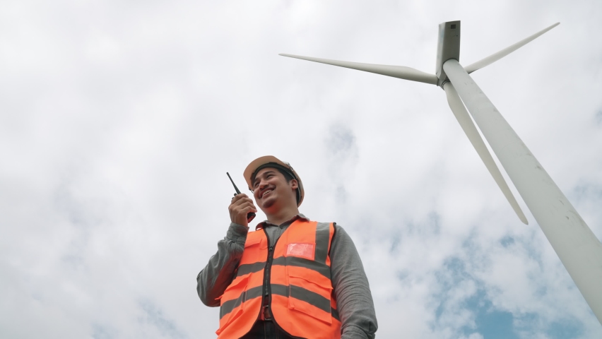 Engineer working on a wind turbine with the sky background. Progressive ideal for the future production of renewable, sustainable energy. Energy generation from wind turbine. | Shutterstock HD Video #1097240911