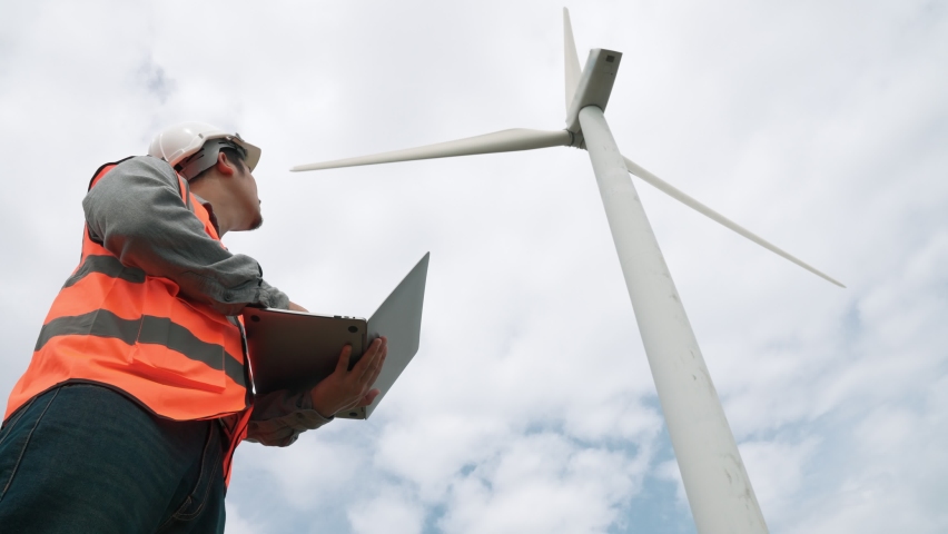 Engineer working on a wind turbine with the sky background. Progressive ideal for the future production of renewable, sustainable energy. Energy generation from wind turbine. | Shutterstock HD Video #1097241013