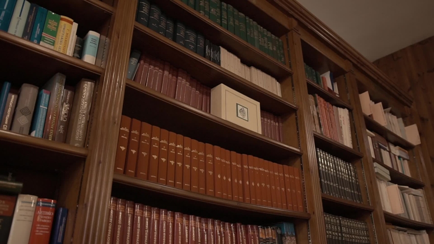 Modern Greek library in a Culture Centre. Bookshelves with traditional volumes: ancient philosophy, Iliad and Odyssey poems, legends and myths. Museum of Spirituality and Wisdom of a Greek community. Royalty-Free Stock Footage #1097241193