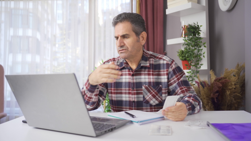Home economics. Family man looking at debts and bills and desperate.
With rising prices and inequality of income and expenditure, the man has difficulties with finances.
 | Shutterstock HD Video #1097243017