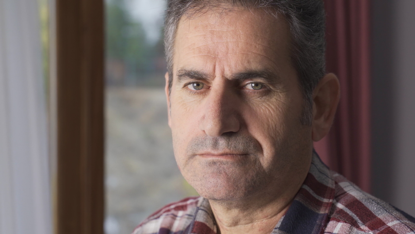 Unhappy man looking out the window.
Unhappy and depressed mature man looks out the window and into the camera.
 | Shutterstock HD Video #1097243105