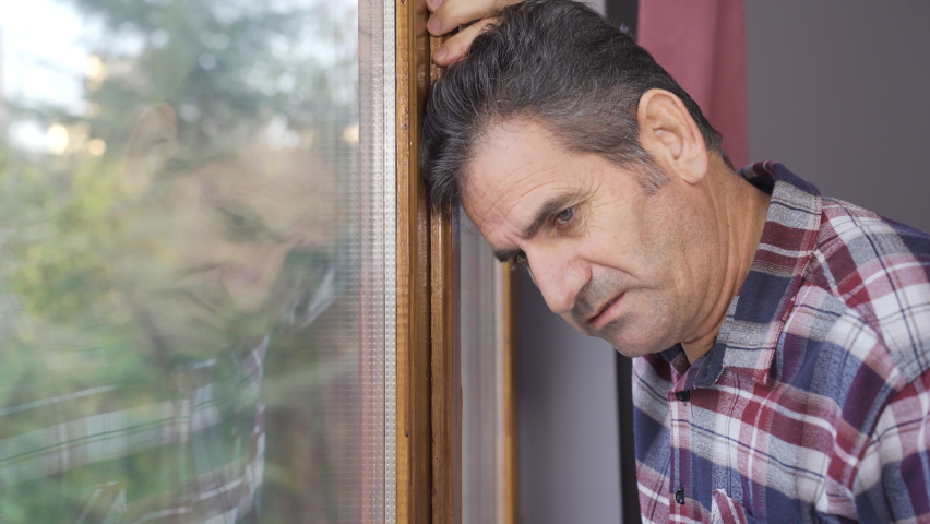 Depressed man looks outside by the window.
The man is at home watching out the window and is thoughtful.
 | Shutterstock HD Video #1097243117