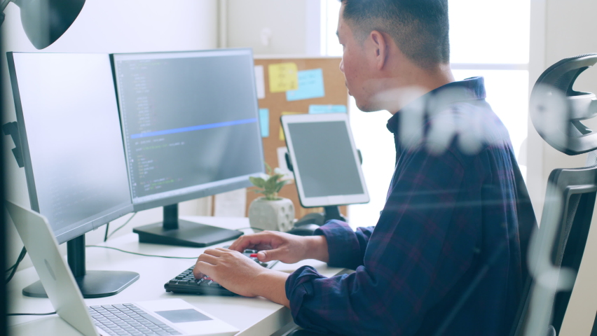 

Young Asian man, developer programmer, software engineer, IT support, working on computer to check coding in bugging system | Shutterstock HD Video #1097245485
