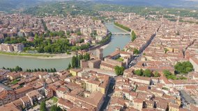Inscription on video. Verona, Italy. Flying over the historic city center. Scaliger Bridge. Castelvecchio Castello Scaligero, summer. Name is burning, Aerial View, Departure of the camera