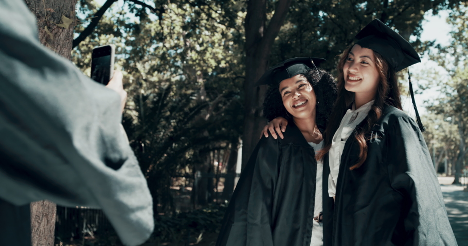 Students, graduation or celebration hug in phone picture on college, school or university campus. Happy smile, education graduates and friends or learning women in embrace in social media photography | Shutterstock HD Video #1097247171