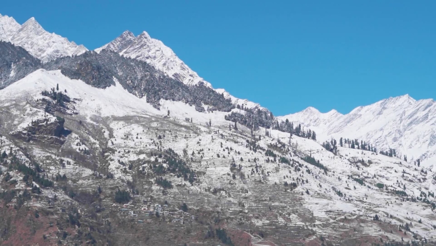 Handheld shot of snow covered mountains after snowfall during the winter season at Manali in Himachal Pradesh, India. Himalayan Mountains covered by snow after snowfall. Nature background. | Shutterstock HD Video #1097248517