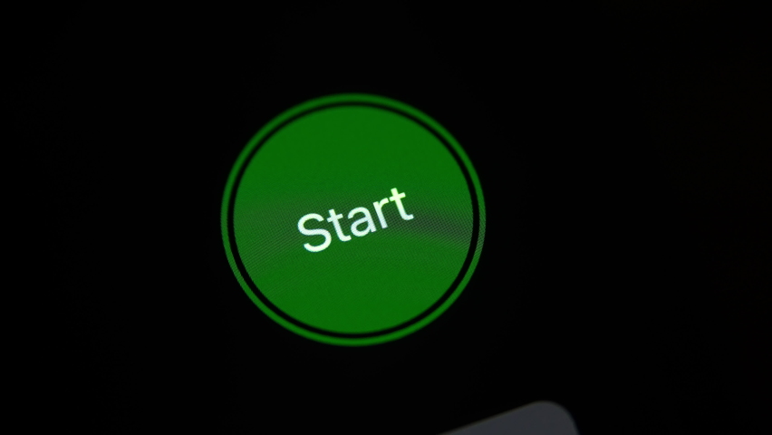 finger push start button on touch screen, close up. press green key on digital sensor display. detailed macro shot of a click on round green button on tablet or smartphone. remote control technology