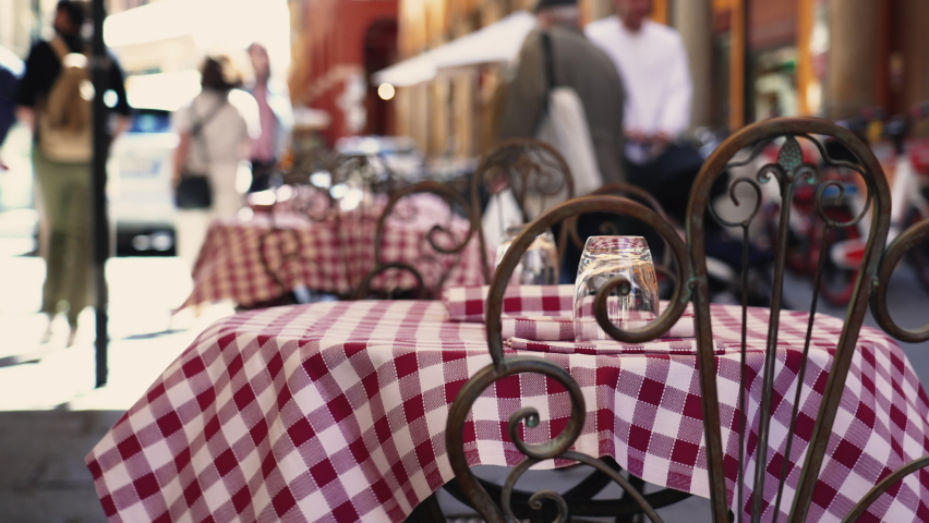 Italian Restaurant table with nobody. Wind flowing on tablecloth outside in European street sidewalk Royalty-Free Stock Footage #1097250815