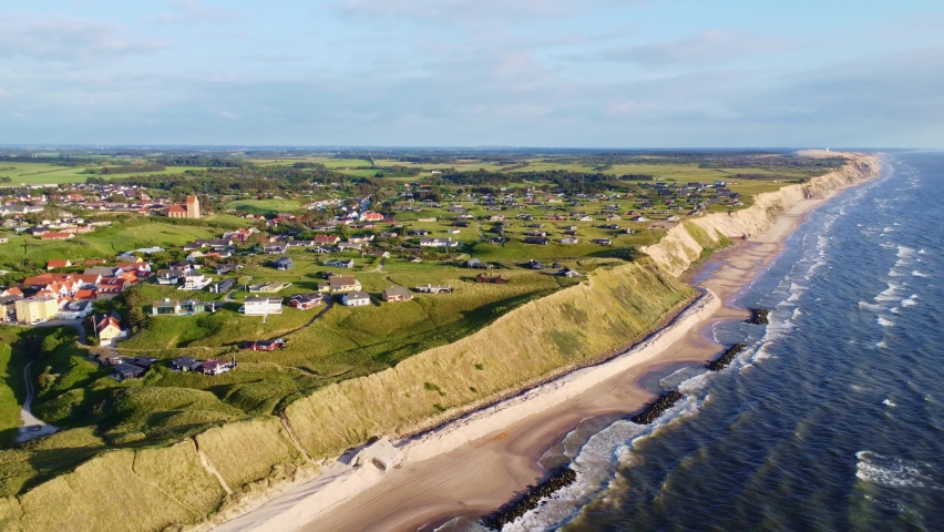 Aerial drone view of the idyllic ocean coast line in Denmark around the village of Lønstrup on a summer day Royalty-Free Stock Footage #1097251089