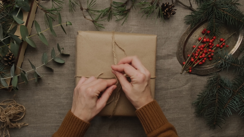 Female hands wrapping Christmas present.  | Shutterstock HD Video #1097251397