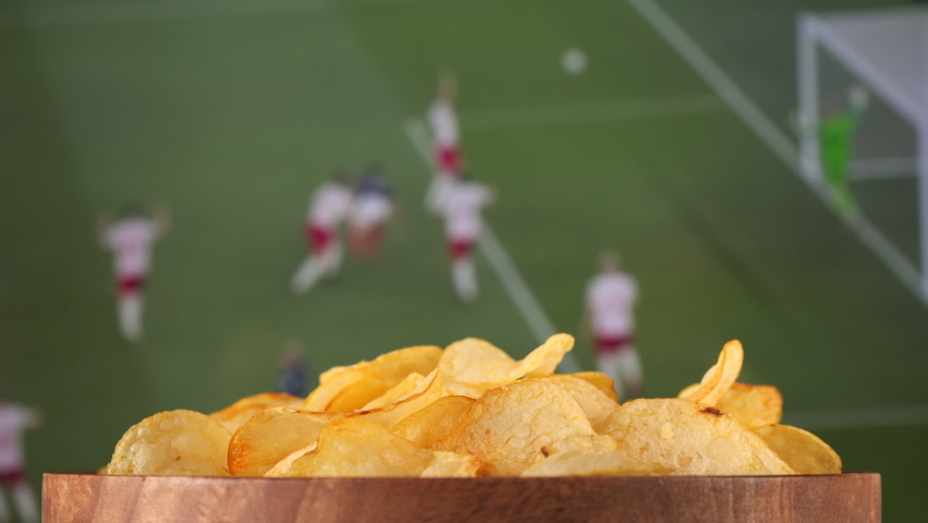 Couple Watching football match on tv and eating snack potatoes chips | Shutterstock HD Video #1097255955