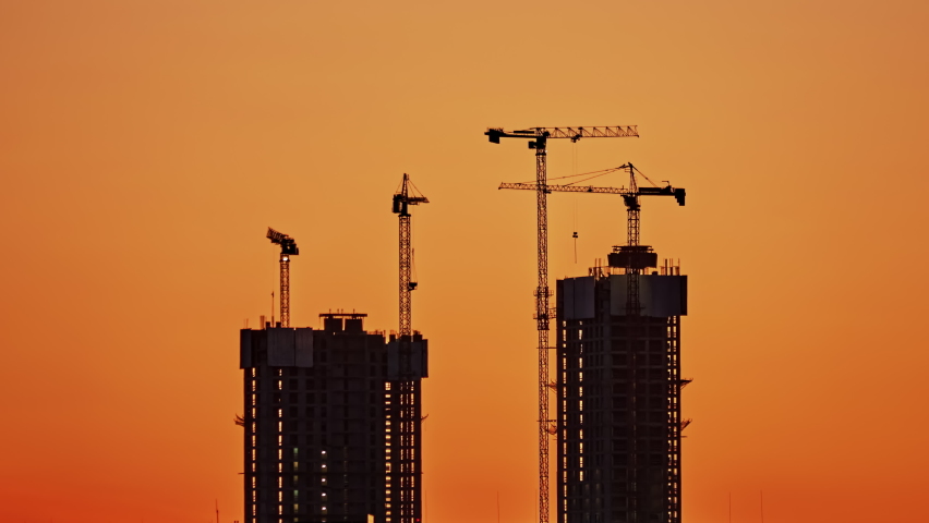 Time lapse of four high-rise construction cranes on the construction of two skyscrapers. Interval shooting day and night. The concept of modern construction processes and construction technologies Royalty-Free Stock Footage #1097257041