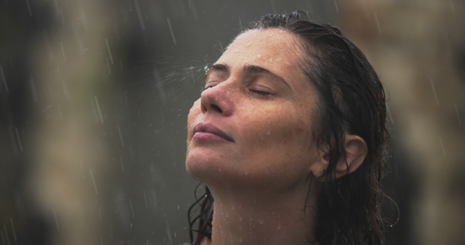 Calm woman 40s taking deep breath of fresh air meditating with eyes closed standing outdoor in the rain, close up side profile view. Woman Enjoy moment, here and now, living feels | Shutterstock HD Video #1097257351