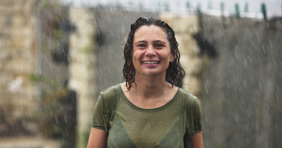 Happy Laughter Joyful Female Listen Music and Dance in Summer Rain. Caucasian Young Woman Arms Raised Enjoy Nature. Having Fun Celebrating with Funny Dance Moves Enjoying Freedom. Slow Motion Close Up | Shutterstock HD Video #1097257355