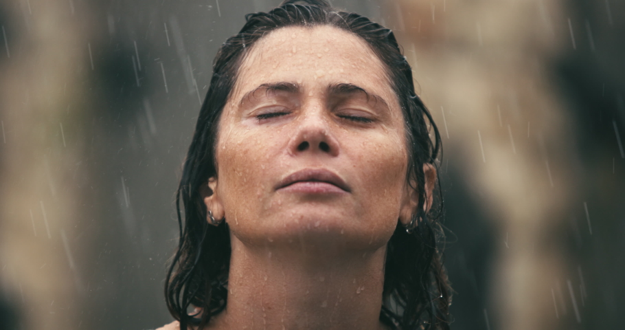 Close up of Woman 40s Face in the rain, Natural Beauty Face Female with drop rain on face. Woman relax outdoor in autumn rainy day. Health care, authenticity, sense of balance zen and calmness. | Shutterstock HD Video #1097257359
