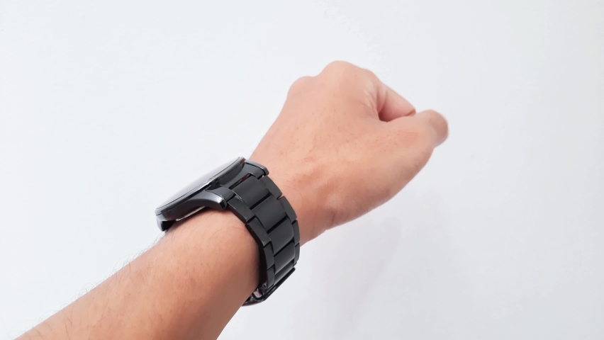 Close-up of person wearing a watch in the left hand. Black watch with chain strap. | Shutterstock HD Video #1097258565