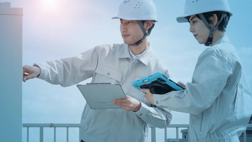Worker inspecting equipment with a tablet and communication network concept. IIoT. Industrial Internet of Things. Royalty-Free Stock Footage #1097274013
