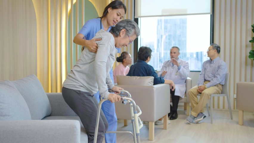 Attractive young asian woman or nurse take care senior old woman on cane or walker feeling helpful and empathy at nursing home or hospital hallway, hip, knee and leg problem in older people. | Shutterstock HD Video #1097275959