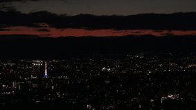 KYOTO, JAPAN - DECEMBER 2021 : Aerial high angle view of Kyoto city at night. Scenery of streets and buildings around Kyoto station. Japanese urban nightlife city concept video.