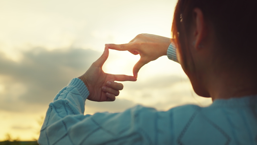 B roll - New year planning and vision concept, Close up of woman hands making frame gesture with sunset in winter, Female capturing the sunrise.