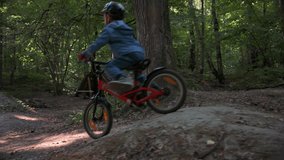 Boy riding on bicycle in the forest. Riding on a hills. 4k video footage UHD 3840x2160