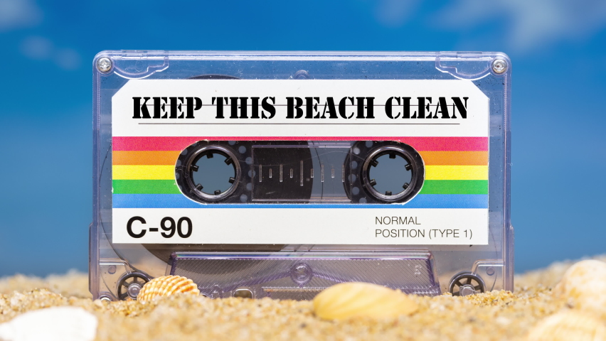 A cassette tape on a beach with words keep this beach clean | Shutterstock HD Video #1097281271