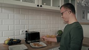 Adult caucasian man with down syndrome preparing and passing breakfast to his mom. Shot with RED helium camera in 8K.    