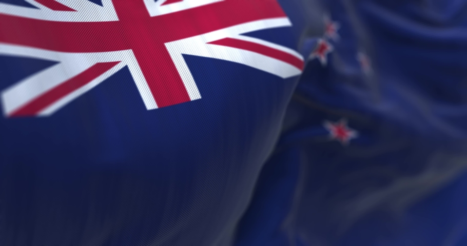 Close-up view of the New Zealand national flag waving in the wind. New Zealand is an island state of Oceania. Fabric textured background. Selective focus. Infinite loop in slow motion. 3D render