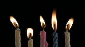 HD 1080p: Melting candles on black background - all but one blown out