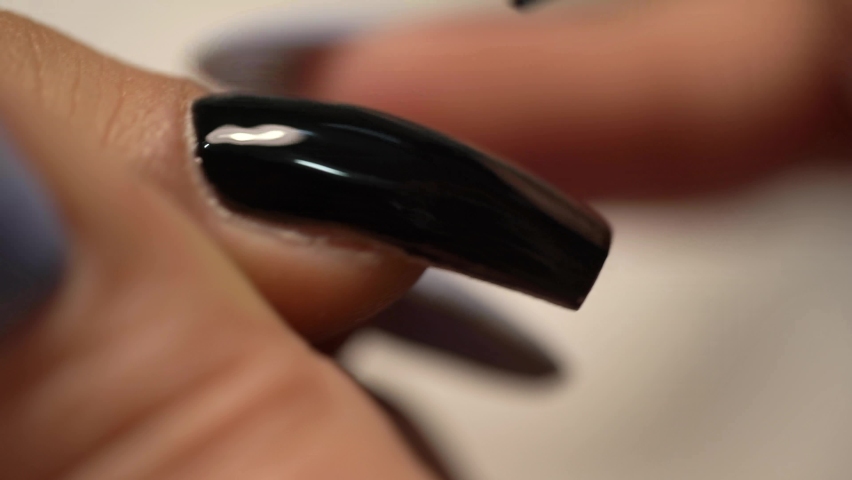 
Black manicure on nail. Close view the manicurist paints her nails with black gel polish.


 Royalty-Free Stock Footage #1097284569