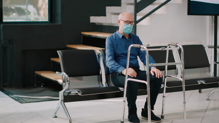 Little kid and woman visiting old patient in health center, bringing bouquet of flowers in hospital reception. People talking to senior adult in wheelchair, healthcare appointment.