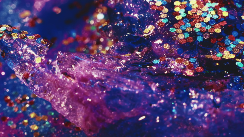 Sparkle magic. Fluid art. Cosmic background. Transparent shimmering stream of liquid paint with colorful tinsels floating in macro shooting. | Shutterstock HD Video #1097289817