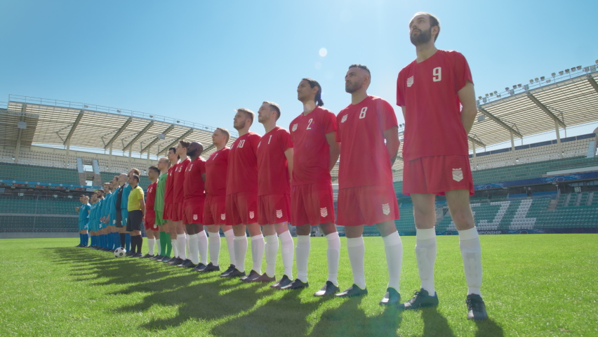 Football Championship: Two Professional Soccer Team ready for a Match. Players One by One, Standing in Line on Stadium. Professional Athletes ready to Win Tournament, Cup. Dolly Wide Camera