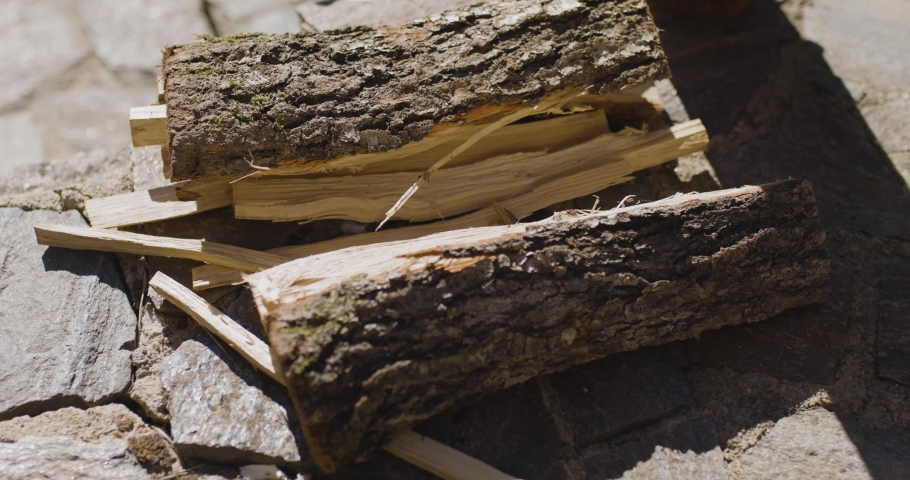 Pile of log wood on a stone surface | Shutterstock HD Video #1097292487