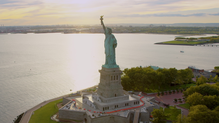
Aerial Orbit of Statue of Liberty in Liberty Island, New York City. United States. This Magnificent Sculpture was designed by French sculptor Frédéric Auguste Bartholdi. Backlit. Shot from Helicopter