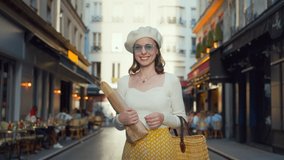 Beautiful girl with baguettes looking at the camera