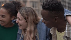 Happy Portrait, slow motion panning of multiethnic group of friends laughing while embracing each other, outdoors in the city, having fun and enjoying of their company. Headshot. - Powered by Shutterstock - Get 15% off with code: PIKWIZARD15