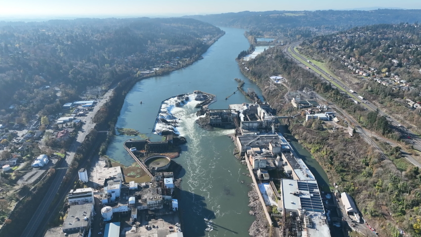 The Willamette Falls is a natural waterfall flowing between West Linn and Oregon City, not far south of Portland, Oregon. By volume, this is the largest waterfall in the Northwestern United States.
