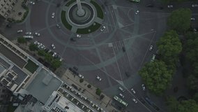 Drone headshot of cars speeding around a square in downtown Los Angeles, Georgia