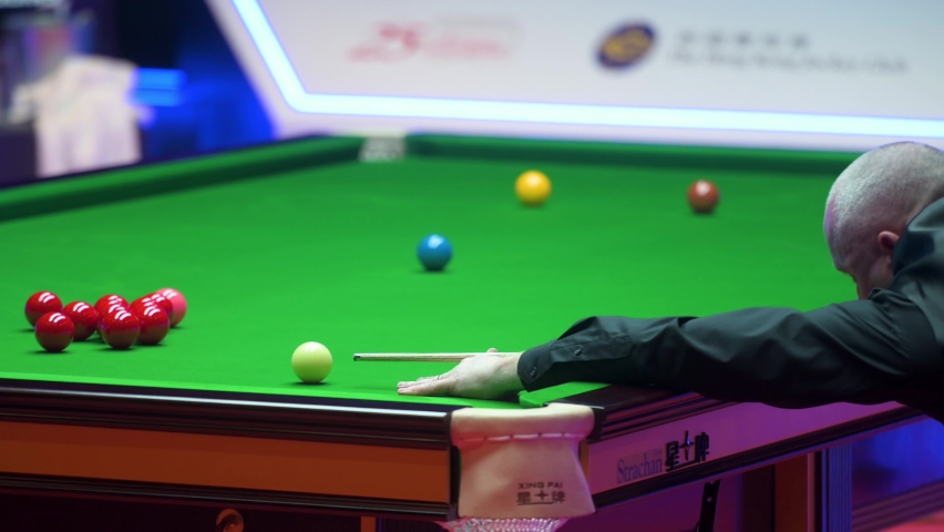 A professional snooker player is seen in action as he strikes a ball during the Hong Kong master tournament competition. | Shutterstock HD Video #1097302843