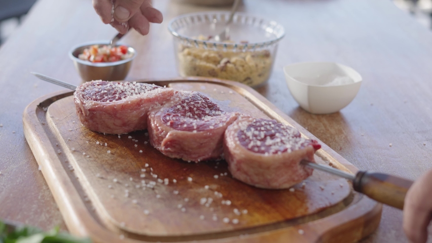 Close up of fresh Picanha being prepared on stick Traditional Churrasco Brazilian Barbecue. Salt being drizzle
 Royalty-Free Stock Footage #1097310085
