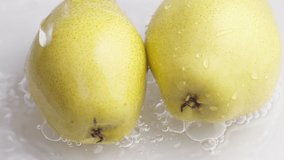 Yellow pear on a blue dark background with drops of water rolling down the pear and flowing splashing with isolated background - Powered by Shutterstock - Get 15% off with code: PIKWIZARD15
